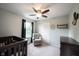 Cozy bedroom with neutral walls, a ceiling fan, and a glider near the window, ideal for a Bedroom or relaxing space at 10982 Gate Cir, Fishers, IN 46038