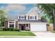 Inviting two-story home with brick and vinyl siding, attached garage, and well-manicured lawn at 10982 Gate Cir, Fishers, IN 46038