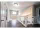 Bright hallway with hardwood floors, white railings, and a view of the stairs at 10982 Gate Cir, Fishers, IN 46038