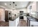 Clean kitchen with stainless steel appliances, a center island, and breakfast bar at 10982 Gate Cir, Fishers, IN 46038