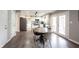Bright eat-in kitchen with stainless steel appliances, white cabinets, and an island with a breakfast bar at 10982 Gate Cir, Fishers, IN 46038