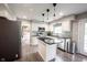 Clean eat-in kitchen with stainless steel appliances, a center island, and ample counter space at 10982 Gate Cir, Fishers, IN 46038