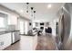 Open concept living area with an eat-in kitchen, fireplace, and hardwood floors at 10982 Gate Cir, Fishers, IN 46038