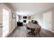 Open concept living and dining area with fireplace and neutral walls at 10982 Gate Cir, Fishers, IN 46038