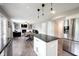 Open concept kitchen, dining, and living room with stainless steel appliances and hardwood floors at 10982 Gate Cir, Fishers, IN 46038
