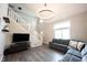 Open living room featuring hardwood floors, staircase, and an inviting gray sectional sofa at 10982 Gate Cir, Fishers, IN 46038