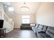 Inviting living room showcasing hardwood floors, neutral walls, and a stylish gray sectional sofa at 10982 Gate Cir, Fishers, IN 46038