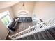 Open floor plan featuring a large sectional couch, hardwood floors, and statement lighting at 10982 Gate Cir, Fishers, IN 46038