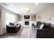 Cozy living room with a white brick fireplace, a flatscreen TV, and comfortable seating at 10982 Gate Cir, Fishers, IN 46038