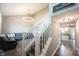 Bright living room featuring hardwood floors, stairs and a modern chandelier at 10982 Gate Cir, Fishers, IN 46038