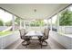 Relaxing screened patio with outdoor dining set and view of backyard at 10982 Gate Cir, Fishers, IN 46038