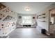 Bright playroom with a climbing wall, window bench, and gray laminate wood flooring at 10982 Gate Cir, Fishers, IN 46038