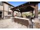 Backyard patio features built-in grill and comfortable seating under a pergola at 1122 Mill Run Dr, Noblesville, IN 46062