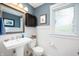 Cozy powder room with pedestal sink, beadboard, and framed mirror at 1122 Mill Run Dr, Noblesville, IN 46062