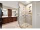 Luxury bathroom with walk-in shower, dual sink vanity and dark wood cabinetry at 1122 Mill Run Dr, Noblesville, IN 46062