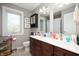 Bathroom features double vanity, bright light fixtures, and unique cartoon shower curtain at 1122 Mill Run Dr, Noblesville, IN 46062