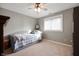 This cozy bedroom is brightly lit with a bed, warm carpet and ceiling fan at 1122 Mill Run Dr, Noblesville, IN 46062