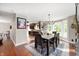 Dining room featuring hardwood floors, a chandelier, and view into a modern kitchen at 1122 Mill Run Dr, Noblesville, IN 46062