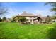 Expansive backyard showcases a well-manicured lawn and multiple entertaining areas at 1122 Mill Run Dr, Noblesville, IN 46062