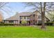 Charming Tudor-style home with a well-manicured lawn and mature landscaping at 1122 Mill Run Dr, Noblesville, IN 46062