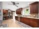 Kitchen with dark wood cabinetry, stainless steel appliances, and ceramic tile floors at 1122 Mill Run Dr, Noblesville, IN 46062