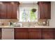 Kitchen sink with stainless steel fixtures, granite countertops and wooden cabinets at 1122 Mill Run Dr, Noblesville, IN 46062