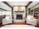 Cozy living room featuring built-in bookshelves, a fireplace and comfortable chairs at 1122 Mill Run Dr, Noblesville, IN 46062