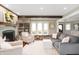 Bright living room featuring hardwood floors, fireplace, and a comfortable seating area at 1122 Mill Run Dr, Noblesville, IN 46062