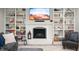 Basement living area with a white brick fireplace, built-ins, and neutral decor at 1122 Mill Run Dr, Noblesville, IN 46062