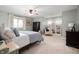 Well lit main bedroom with light green walls, carpet and large windows at 1122 Mill Run Dr, Noblesville, IN 46062
