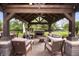 Beautiful outdoor living space with fireplace, comfortable seating and ceiling fan at 1122 Mill Run Dr, Noblesville, IN 46062
