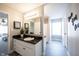 Well-lit bathroom with long vanity, white sink and cabinets, and modern wood-look floors at 11327 Guy St, Fishers, IN 46038