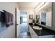 Bathroom with a granite-like vanity, white cabinets, and wood-look floors seen from doorway at 11327 Guy St, Fishers, IN 46038