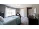 Neutral bedroom with a cozy bed, a large window, and ample natural light, offering a serene and relaxing space at 11327 Guy St, Fishers, IN 46038