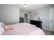 Bedroom features pink bedding, carpet floors, and plenty of natural light through the windows at 11327 Guy St, Fishers, IN 46038