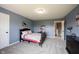 Cozy bedroom with soft carpeting, blue walls, a wooden-frame bed, and closet with a white door at 11327 Guy St, Fishers, IN 46038