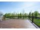 Expansive wooden deck overlooking a lush green backyard with trees, providing an ideal outdoor entertaining space at 11327 Guy St, Fishers, IN 46038