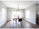 Dining room with modern lighting, table and chairs with view to the outdoors at 11327 Guy St, Fishers, IN 46038