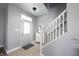 Bright entryway featuring tile floors, a staircase, shoe storage and stylish decor at 11327 Guy St, Fishers, IN 46038