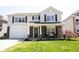 Inviting two-story home featuring a two-car garage, brick accents, and a covered front porch at 11327 Guy St, Fishers, IN 46038