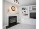 Close-up of a fireplace with tile surround and built-in shelving in living room at 11327 Guy St, Fishers, IN 46038