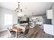 Open floor plan with kitchen island, dining table and stainless steel appliances at 11327 Guy St, Fishers, IN 46038