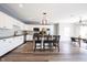 Modern kitchen with white cabinets, a center island with seating, and wood floors at 11327 Guy St, Fishers, IN 46038