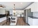 Open kitchen featuring white cabinets, stainless steel appliances, and an island with breakfast bar seating at 11327 Guy St, Fishers, IN 46038