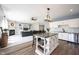 Spacious kitchen with white cabinets, an island and stainless appliances open to the living room at 11327 Guy St, Fishers, IN 46038