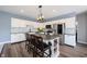 Bright kitchen with white cabinets, stainless steel appliances, and a large island with bar seating at 11327 Guy St, Fishers, IN 46038