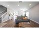 Comfortable living room with hardwood floors, neutral tones, and a staircase at 11327 Guy St, Fishers, IN 46038