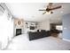 Spacious living room with a fireplace, built-in shelving, and comfortable seating area at 11327 Guy St, Fishers, IN 46038