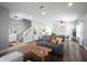 Open-concept living room flows into the dining area with hardwood floors and modern decor at 11327 Guy St, Fishers, IN 46038
