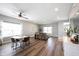 Open-concept living room with hardwood floors, dining area, and comfortable seating at 11327 Guy St, Fishers, IN 46038